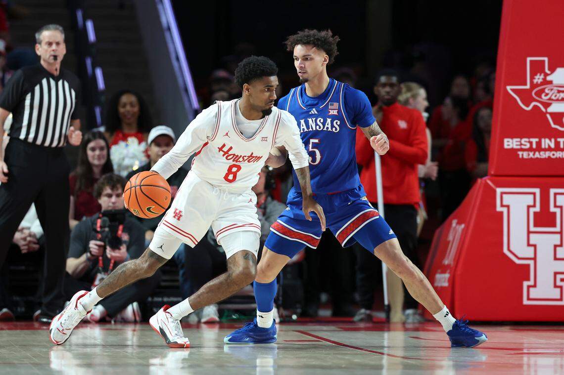 Kansas Jayhawks guard Zeke Mayo (right) defends against Houston Cougars guard Mylik Wilson during a Big 12 college basketball game at the Fertitta Center in Houston on Monday, March 3, 2025.