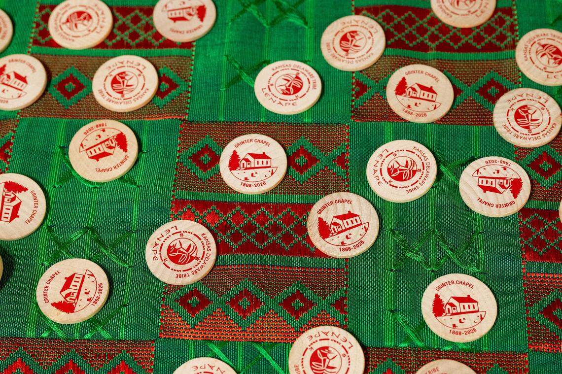 Wooden nickels representing the Kansas Delaware Tribe of Indians, Inc., are laid on a cloth in the basement of Grinter Chapel during a ceremony on Thursday, March 12, 2026, in Kansas City. The deed to the former church property was given back to Kansas Delaware Tribe of Indians, Inc.