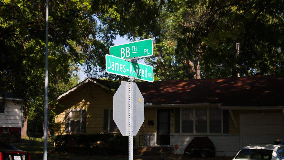 Road signs show the intersection of East 88th Place and James A. Reed Road, where police say a 15-year-old boy was shot on Tuesday and later died at a hospital. As of Thursday, police have been unable to locate a crime scene in or around a park where they believe the shooting happened.