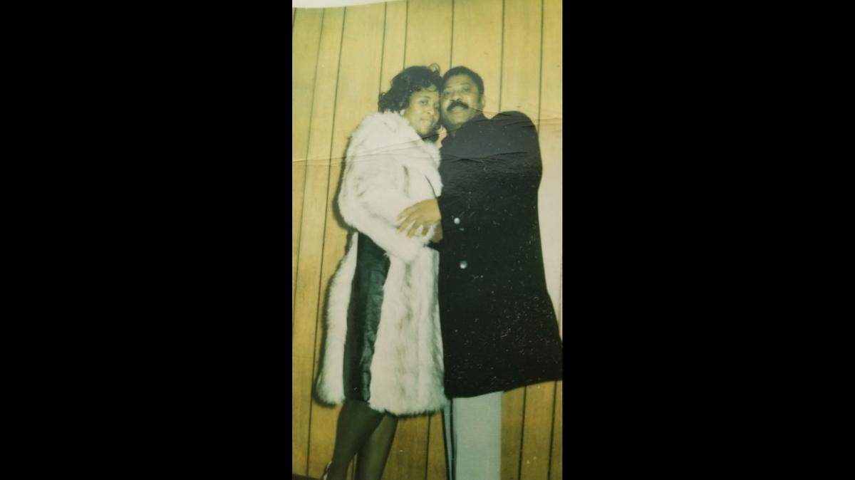 Joe Hubbard (right) and Virginia Hubbard (left) hold each other and smile at the camera. The two met playing golf at Swope Memorial Golf Course, where they both practiced often and competed in tournaments.