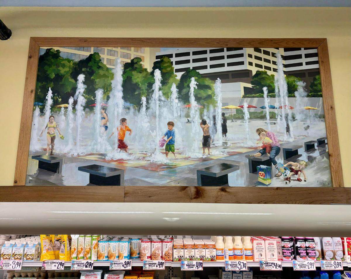 A mural of children playing in the Crown Center Fountains decorates the dairy section in the Ward Parkway Trader Joe’s. Painted by artist Mark Fetty, the painting was completed around 2011, just before the fountains closed to visitors in June 2012. Feb. 27, 2024.