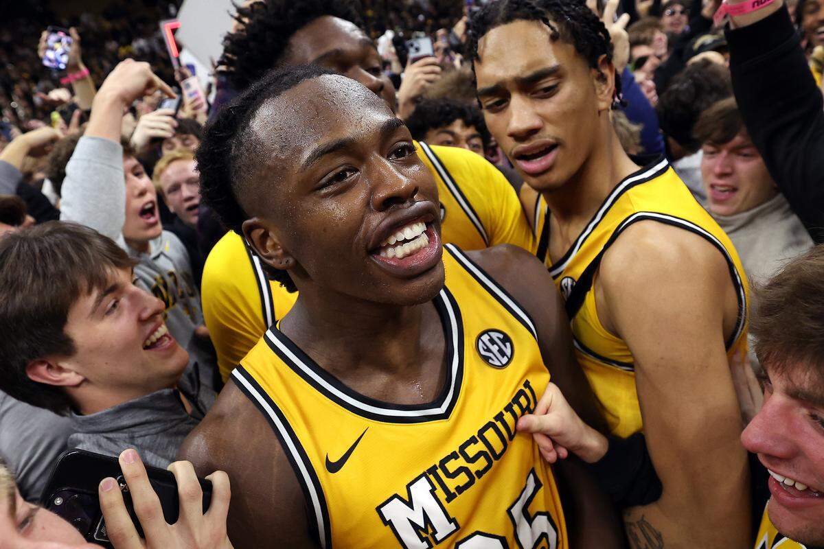 Mark Mitchell #25 of the Missouri Tigers celebrates as fans rush the court as the Tigers defeat the Kansas Jayhawks at Mizzou Arena on December 08, 2024 in Columbia, Missouri.