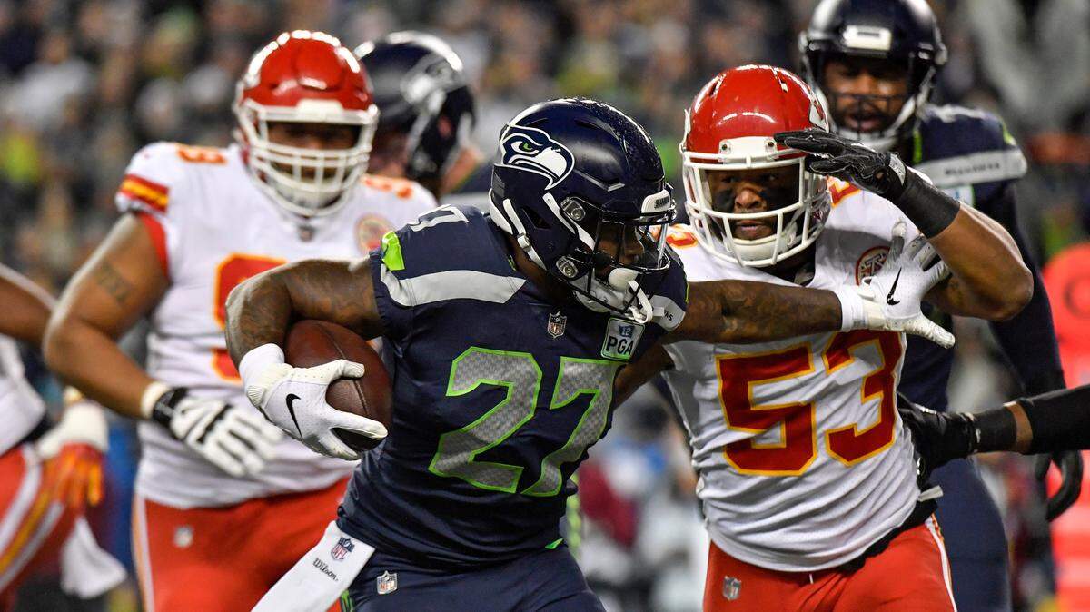 Seattle Seahawks running back Mike Davis outran Kansas City Chiefs inside linebacker Anthony Hitchens for a first down in the first quarter during Sunday’s football game on December 23, 2018 at CenturyLink Field in Seattle, Washington.