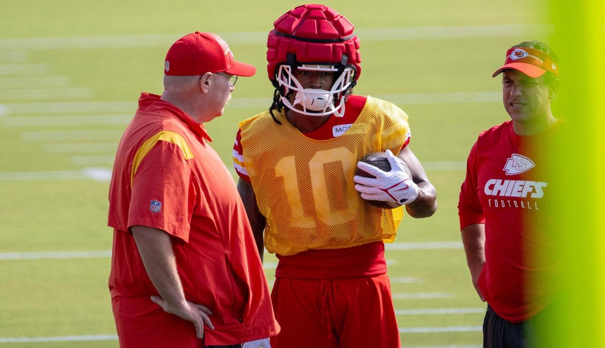 Kansas City Chiefs running back Isiah Pacheco (10) talks with head coach Andy Reid and GM Brett Veach during the first day of NFL football training camp on Wednesday, July 19, 2023, in St. Joseph, Mo.