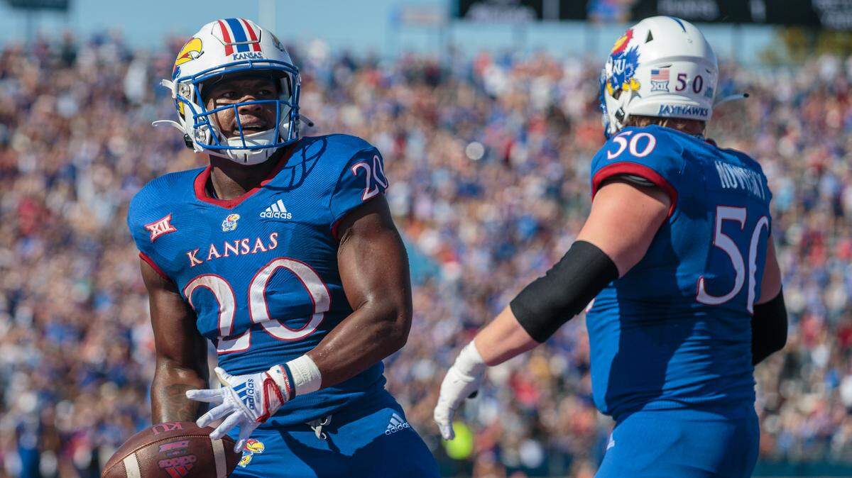 Kansas Jayhawks running back Daniel Hishaw Jr. (20) celebrates after a touchdown during the second quarter against the Iowa State Cyclones at David Booth Kansas Memorial Stadium on Oct. 1, 2022.