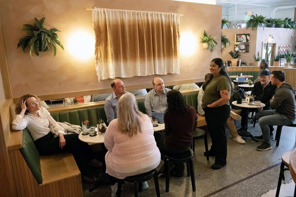 Diana Condori, bartender at the Fern Bar, right, talks with customers on Thursday, March 5, 2026. Condori is the a 2026 nominee for the James Beard award for its Outstanding Professional in Cocktail Service.