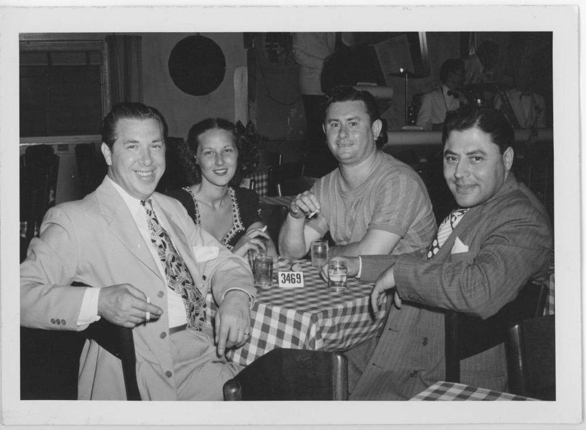 Eddie Osadchey, left, and his wife, Vearl, and two unidentified men.