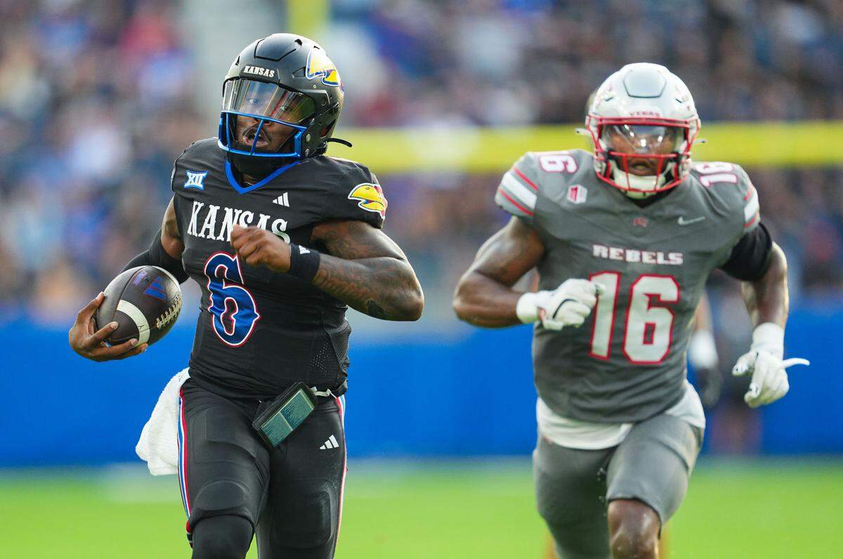 Kansas Jayhawks quarterback Jalon Daniels takes off for one of his two touchdown runs against the UNLV Rebels on Friday night at Children’s Mercy Park in Kansas City, Kan.