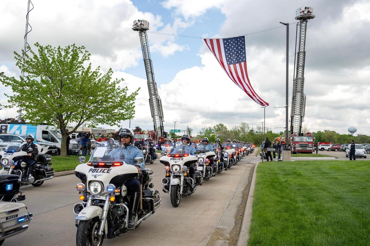 Police officers on motorcycles lead the funeral procession for Kansas City Fire Department firefighter Graham Hoffman on Friday, May 2, 2025, through Liberty. First responders and community members gathered to honor his life and service.