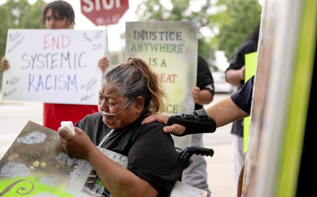 Maria Guzman cries during a protest outside of the Jackson County Family Court on Friday, May 12, 2023, in Kansas City. Guzman’s grandson, Manuel, was stabbed to death by another student at Northeast Middle School in 2022. Family members and friends gathered to protest the plea deal offered to the young boy who killed Manuel.