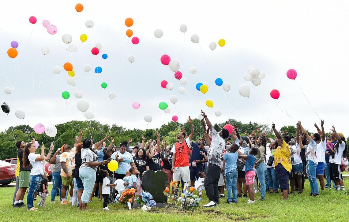 On the one-year anniversary of his death Tuesday, June 29, 2021, family and friends of LeGend Taliferro gathered at his grave at XII Gates Memorial Gardens in Kansas City and released balloons to remember the 4-year-old boy who was fatally shot while sleeping. LeGend’s father, Rapheal Taliferro, center, in orange, counted down to the balloon release.