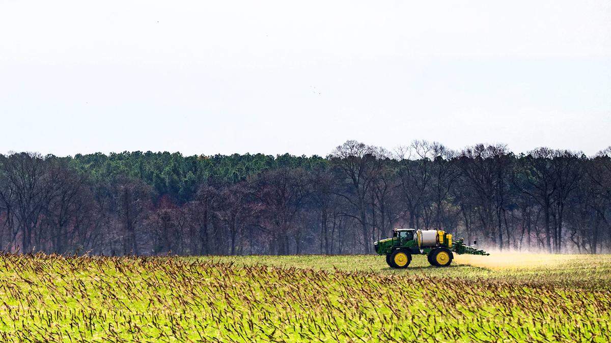 A tractor fertilizes the ground on a farm in Ruthsburg, MD on March 20, 2025. (Photo by Jim WATSON / AFP) (Photo by JIM WATSON/AFP via Getty Images)