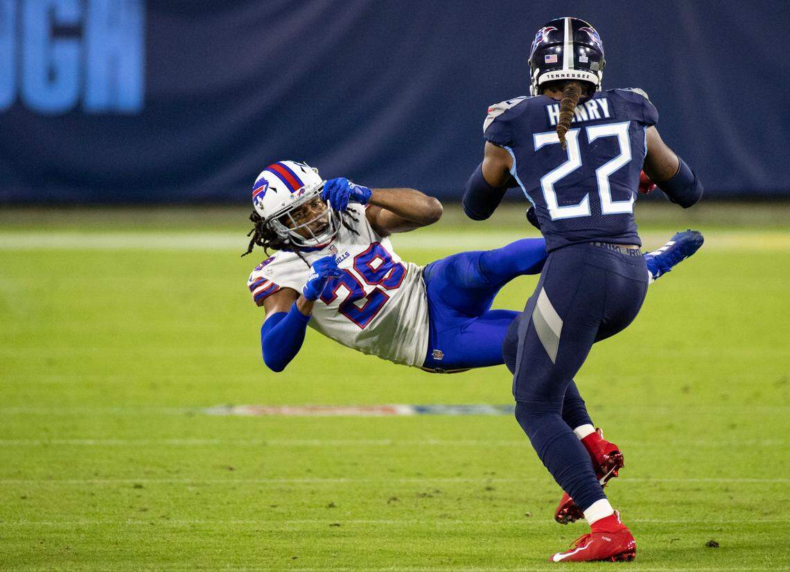 Tennessee Titans running back Derrick Henry (22) stiff arms Buffalo Bills cornerback Josh Norman (29) during the second quarter of an NFL football game, Tuesday, Oct. 13, 2020, in Nashville, Tenn. (AP Photo/Brett Carlsen)