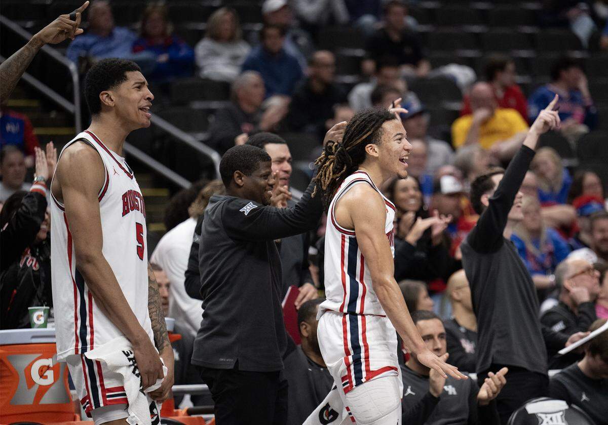 Houston Cougars center Chris Cenac Jr. (5) and guard Kingston Flemings (4) celebrate as the team closed in on a win over the Kansas Jayhawks, 69-47, at the Big 12 Men's Basketball Tournament at T-Mobile Center on Friday, March 13, 2026, in Kansas City. 69-47. 