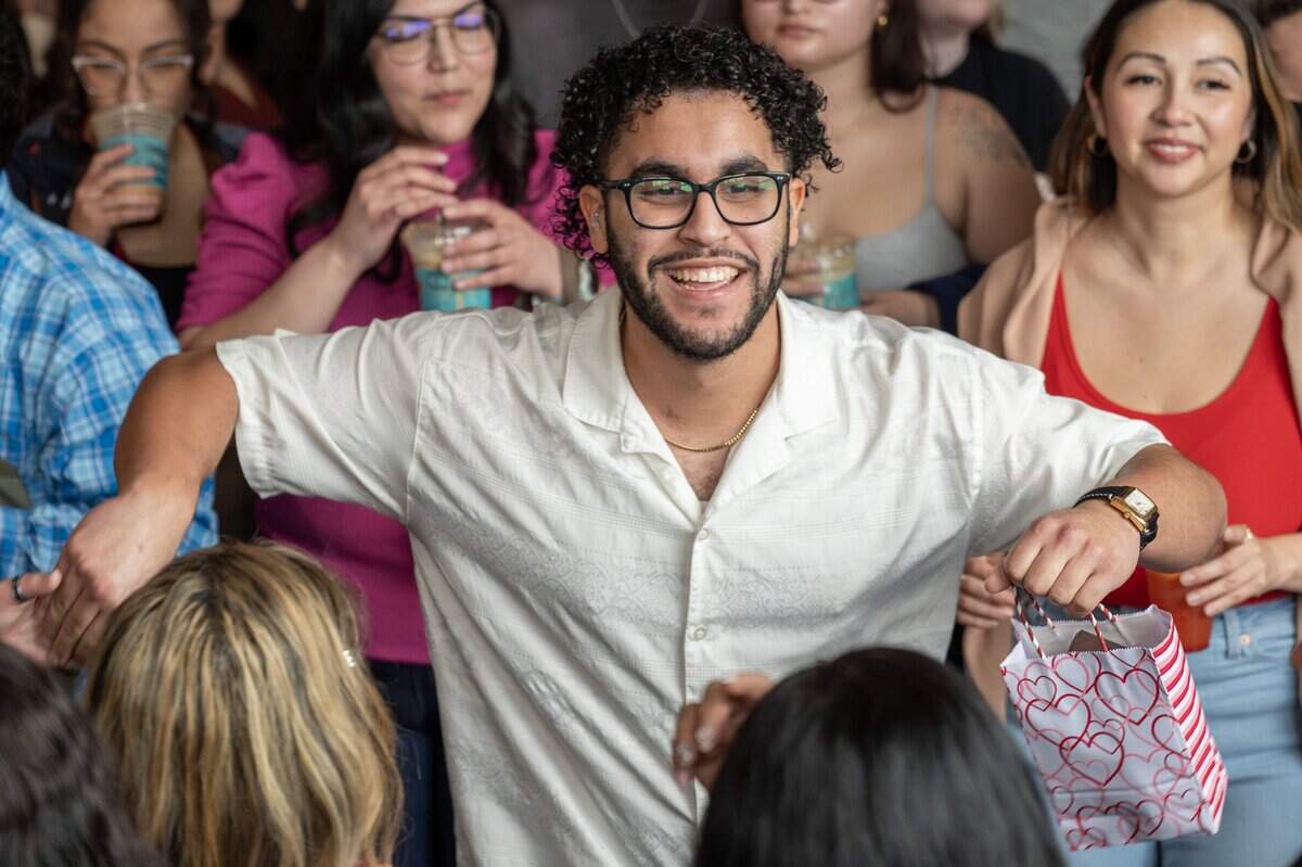 Nelson Rivera, winner of the Bad Bunny look-alike contest, smiles while dancing at Café Corazón on Saturday, Feb. 14, 2026, in Kansas City.