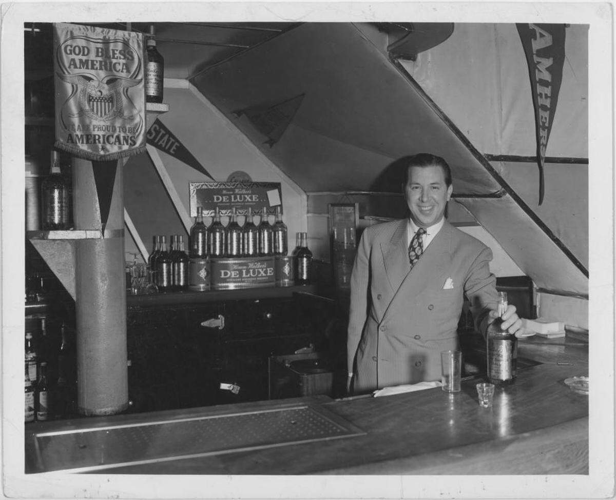 Edward “Eddie Spitz” Ochadsey behind his bar at the College Inn.