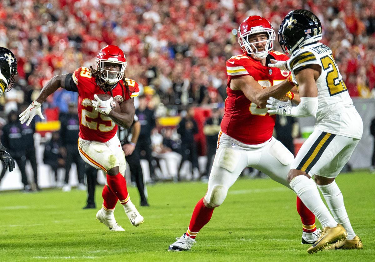 Kansas City Chiefs running back Kareem Hunt (29) ran with the ball as tight end Travis Kelce (87) blocked Saints cornerback Marshon Lattimore (23) in the second half against the New Orleans Saints at GEHA Field at Arrowhead Stadium on Monday, October 7, 2024.