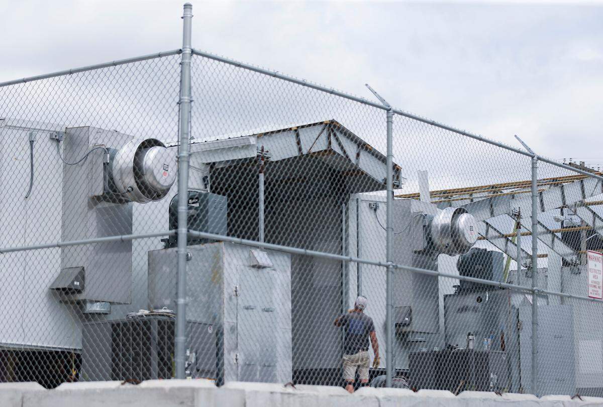 Workers disassemble the Greene County trailer jail located near North Campbell Avenue and West Nichols Street on Friday, July 29, 2022. With the new jail facility open, the trailer jail is no longer needed.Tcounty Presser00238