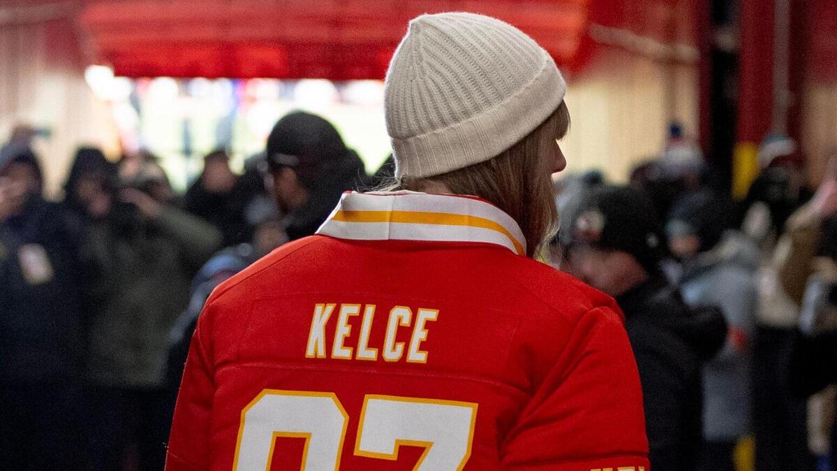 Taylor Swift in a custom winter coat by Kristin Juszczyk made from a Travis Kelce jersey.