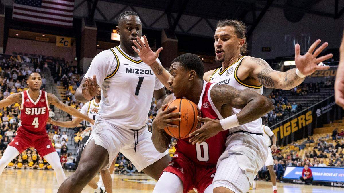 SIU-Edwardsville’s Damarco Minor, center, looks for help against the pressure defense of Missouri’s Kaleb Brown, left, and Tre Gomillion, right, during Tuesday night’s game at Mizzou Arena in Columbia, Mo.