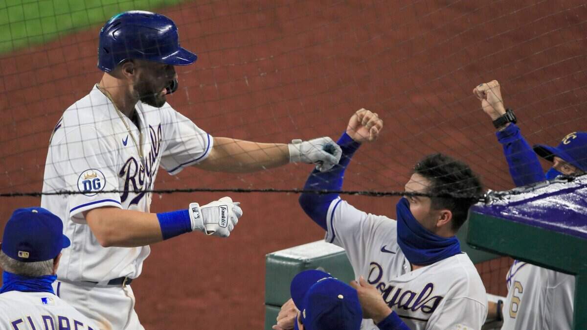 Kansas City Royals’ Ryan McBroom, top left, is greeted at the dugout by teammates after his solo home run in the sixth inning of a baseball game against the Minnesota Twins at Kauffman Stadium in Kansas City, Mo., Friday, Aug. 7, 2020. (AP Photo/Orlin Wagner)