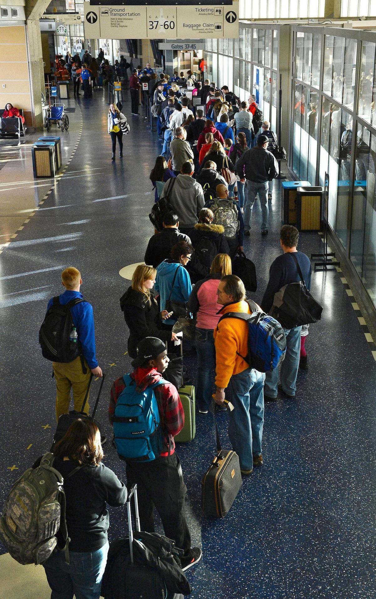 Airline passengers queue up at a security checkpoint in Terminal B of Kansas City International Airport in 2013.