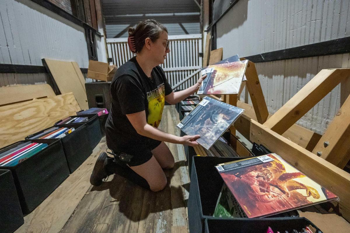 Celia Albon, an employee at Josey Records, shows off limited edition Wu-Tang Clan vinyls, on Friday, April 11, 2025, the day before Record Store Day. The biggest day of the year for small record stores, it brings music fans together for exclusive releases and giveaways.