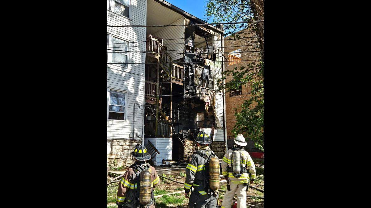 Kansas City firefighters look at the damage done at the Aster building after a fire on April 11 which displaced the tenants living there.