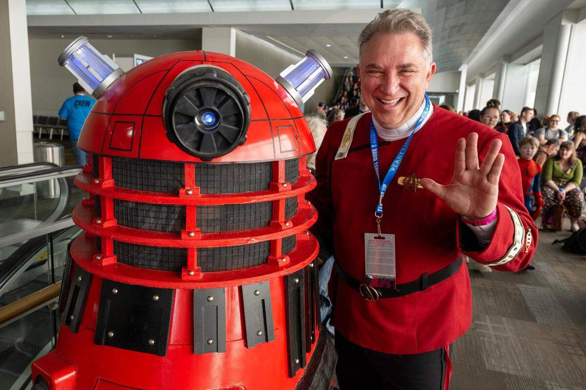 Eric Collins and his son, Alec Collins, cosplay during Planet Comicon at the Kansas City Convention Center on Friday, March 21, 2025. Eric is dressed as a Star Trek character, while Alec cosplays as a Dalek from Doctor Who