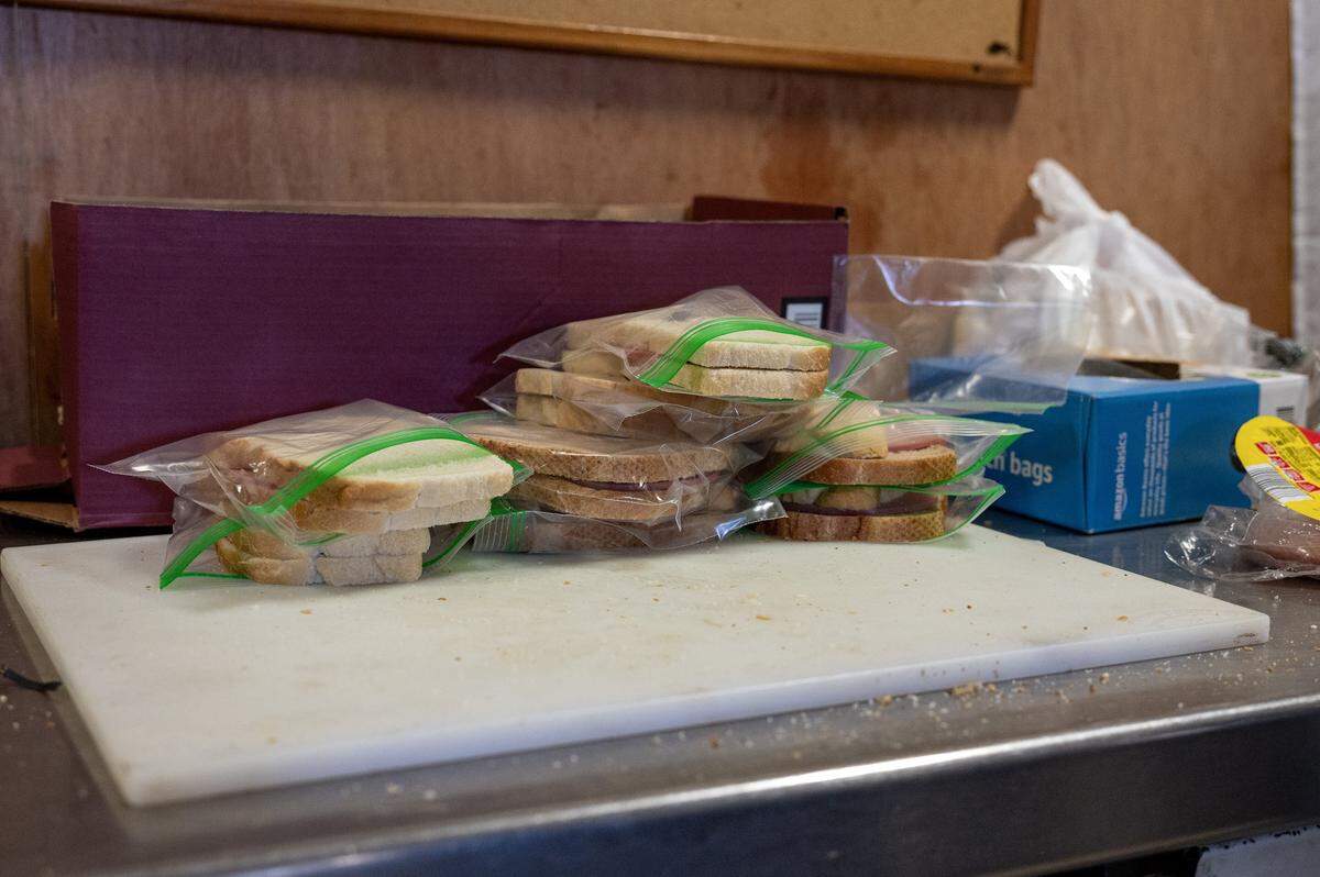 Bologna sandwiches, made by volunteers and packed in small bags, are available for walk up clients at the Redemptorist Center on Monday, Nov. 3, 2025, in Kansas City. Food pantries across the region are struggling to meet demand as many families face reduced or frozen SNAP benefits.