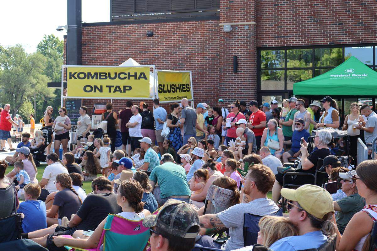 A crowd watches a live performance in the outdoor area of Green Street during the farmers market debut on Saturday, Aug. 16, 2025, in Lee’s Summit.