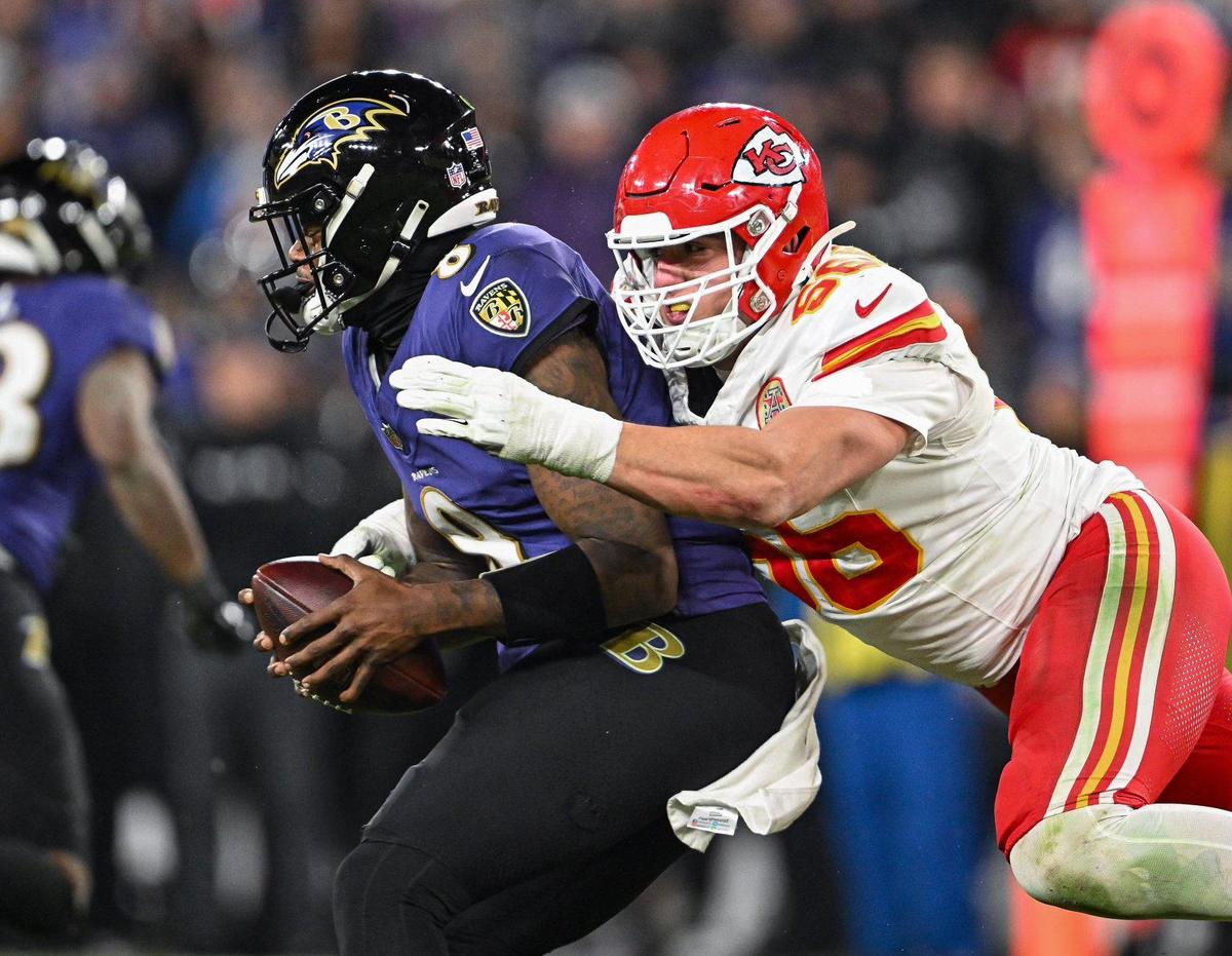 Kansas City Chiefs defensive end George Karlaftis (56) sacks Baltimore Ravens quarterback Lamar Jackson (8) in the fourth quarter Sunday, Jan. 28, 2024, during the AFC Championship Game in Baltimore.