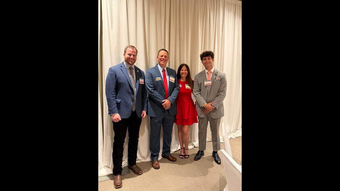 Kansas City council member Nathan Willett, left, stands next to former Kansas City police detective Eric DeValkenaere, his wife, Sarah DeValkenaere, and a campaign staffer at the Clay County Lincoln-Reagan-Trump Day dinner in North Kansas City on April 25, 2026. Willett is mounting a Republican campaign for Missouri’s 6th Congressional District.