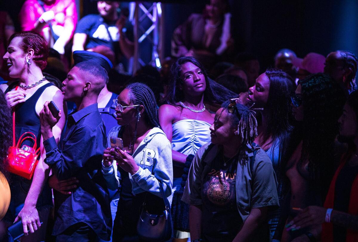 Attendees of the Pride Ball organized by Kansas City Community Pride Alliance watch as a contestant performs a dance at the Uptown Theater on June 9, 2023, in Kansas City. The floor at the Pride Ball quickly filled up leaving eager attendees waiting in long lines outside of the theatre.