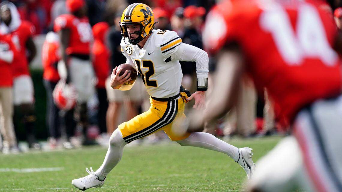 Missouri quarterback Brady Cook (12) runs in the second half of an NCAA college football game against Georgia Saturday, Nov. 6, 2021, in Athens, Ga.