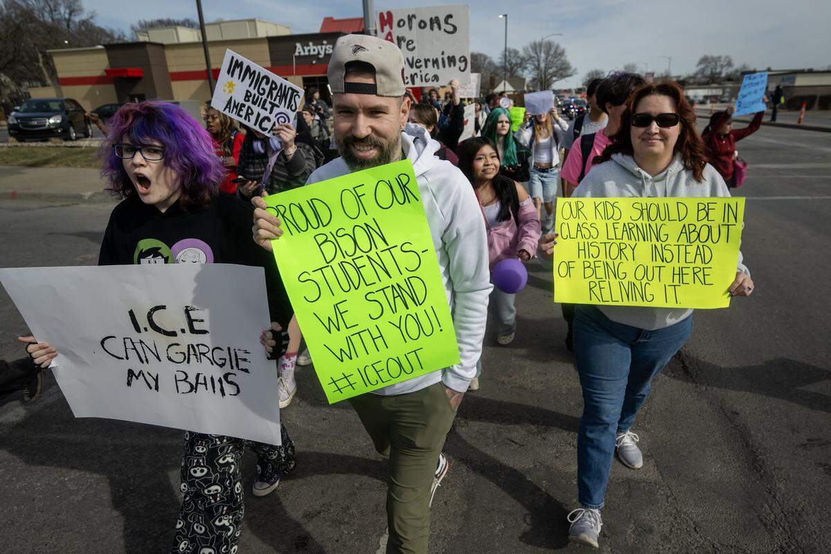 Adults marched with Shawnee Mission North High School students who protested ICE and the Trump administration's policies on Wednesday, February 11, 2026, in Overland Park.