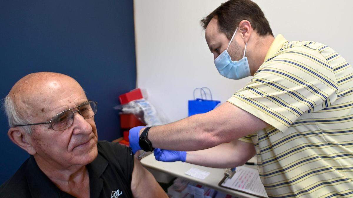 After seeing reports of an increase in cases of COVID-19, George Dragush, 83, of Kansas City, Kansas, had pharmacist Dan Reif give him his second booster shot on Friday, July 15, 2022, at The Medicine Shoppe Pharmacy, 6523 6523 Parallel Parkway in Kansas City, Kansas.