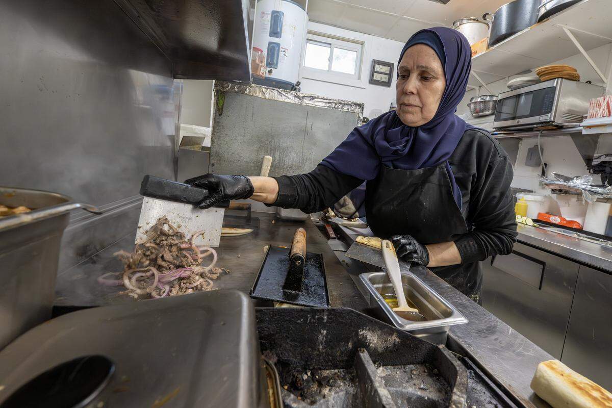 Sabah Majit or “Mama” prepares an order at Hummus and Pita on Tuesday, Sept. 2, 2025, in Overland Park.