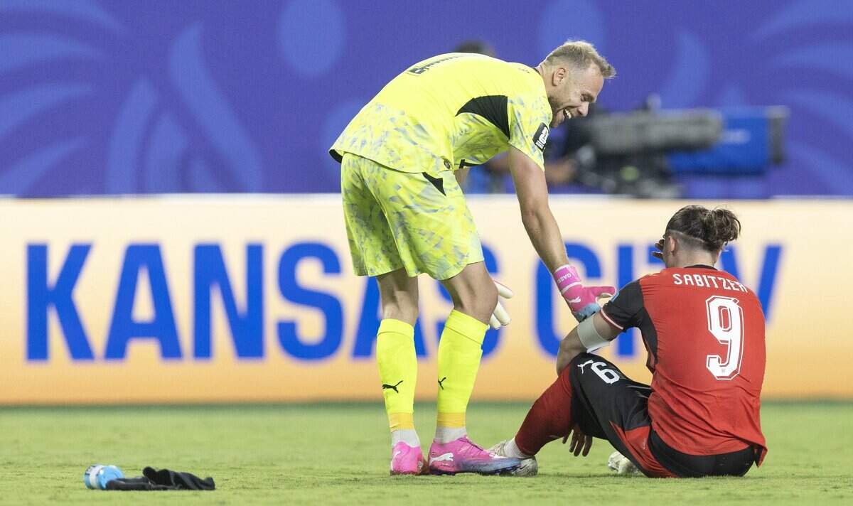Austria goalkeeper Alexander Schlager (1) congratulates teammate Austria midfielder Marcel Sabitzer (9) after thye played Algeria to a draw after a FIFA World Cup group-stage soccer match at Kansas City (Arrowhead) Stadium in Kansas City on Saturday, June 27, 2026.