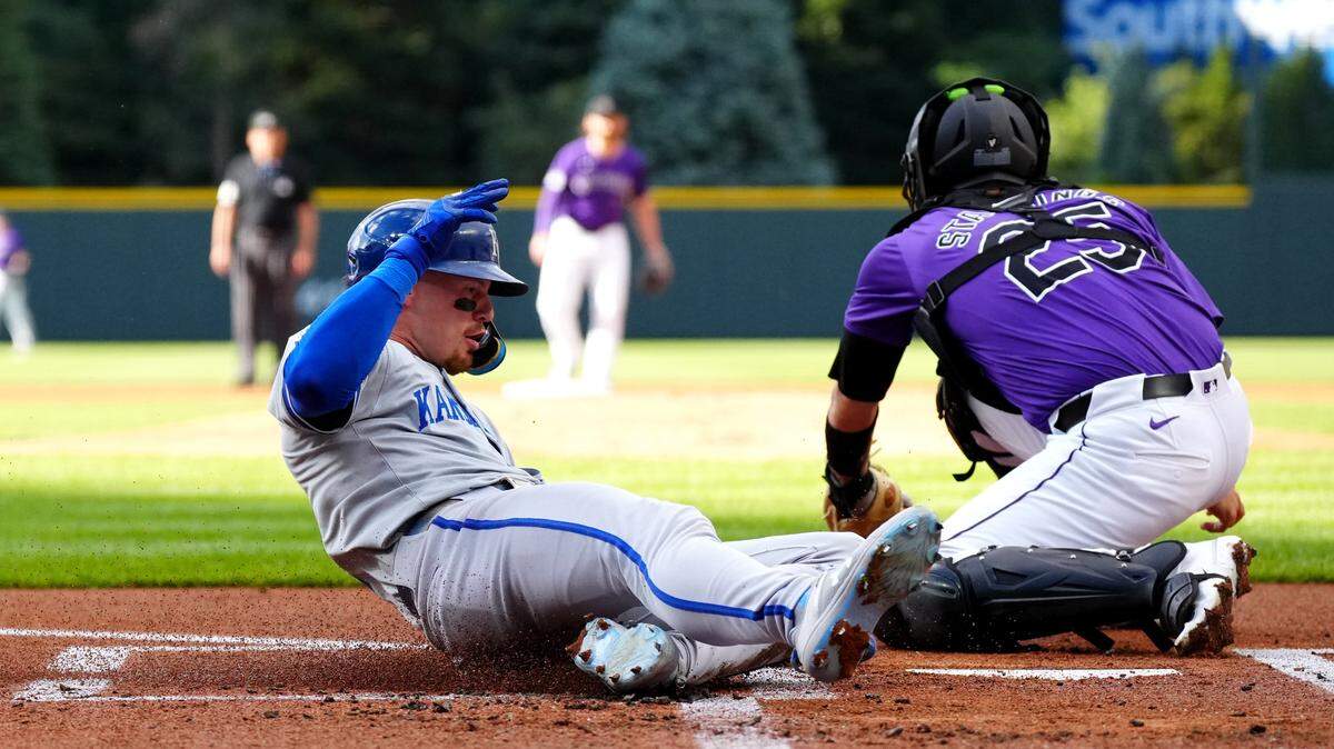Kansas City Royals shortstop Bobby Witt Jr. (7) scores past Colorado Rockies catcher Jacob Stallings (25) in the first inning at Coors Field on July 5, 2024.