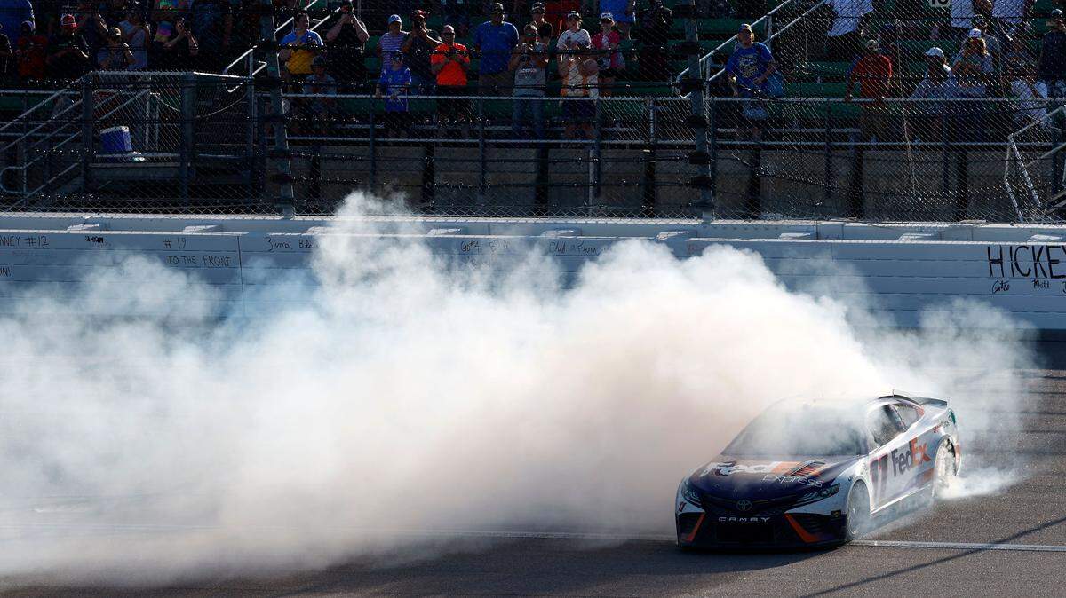 NASCAR Cup driver Denny Hamlin treats spectators to the traditional winner’s smokeshow after prevailing in Sunday’s AdventHealth 400 race at Kansas Speedway in Kansas City, Kan.