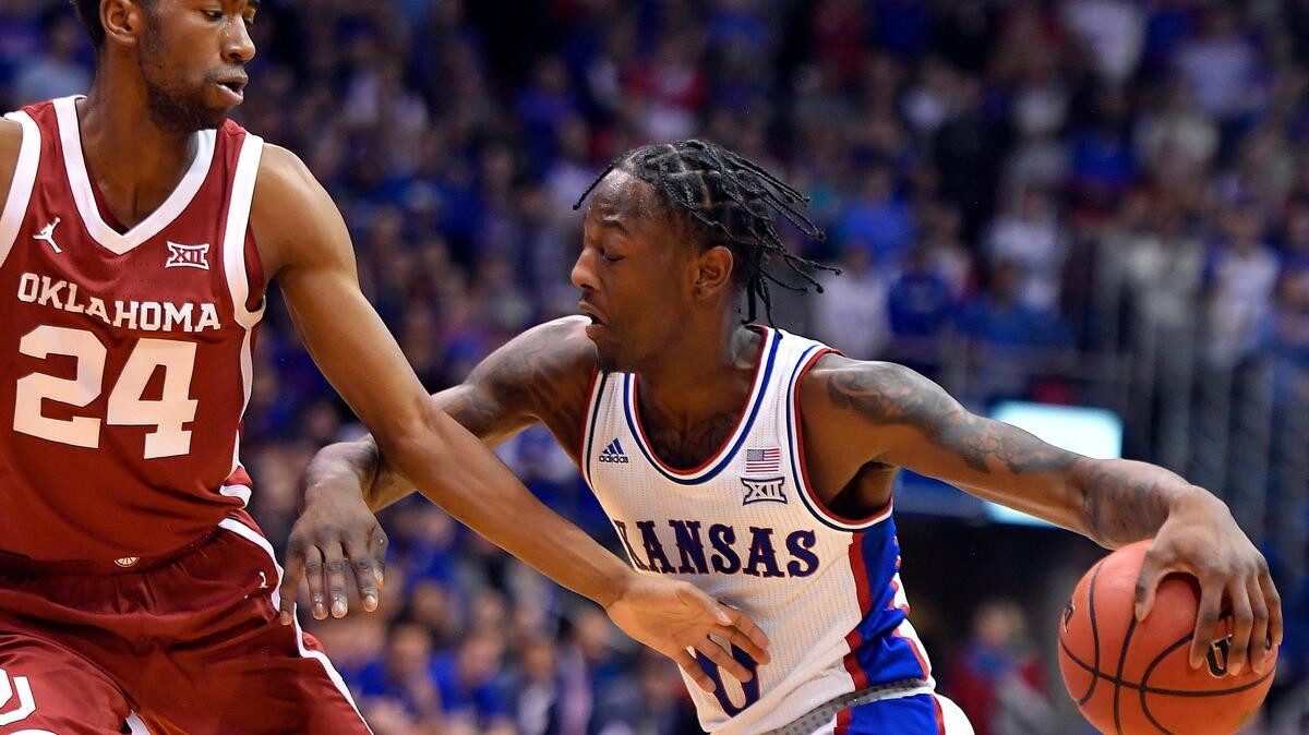 KU’s Marcus Garrett, right, drives to the basket on OU’s Jamal Bieniemy during the first half of KU’s 87-70 win over Oklahoma in the 2019-20 season. Bieniemy now plays for UTEP.