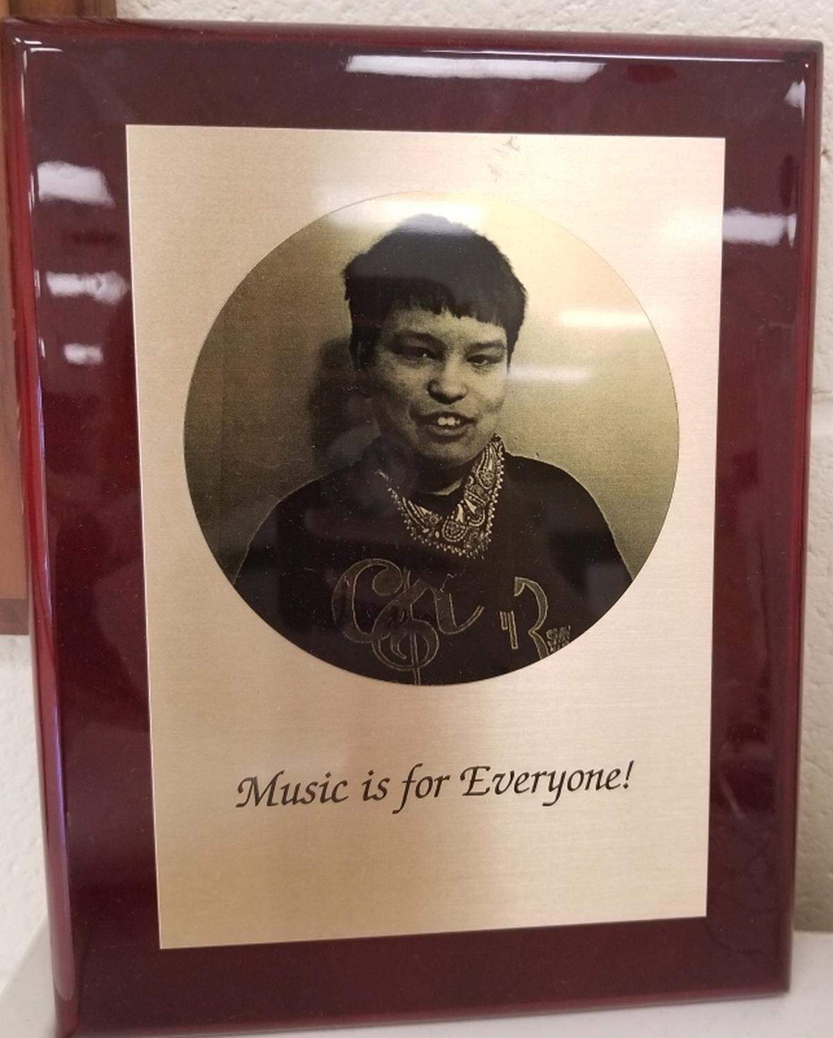 This plaque of Sam Burnes still hangs in the Shawnee Mission North choir room.
