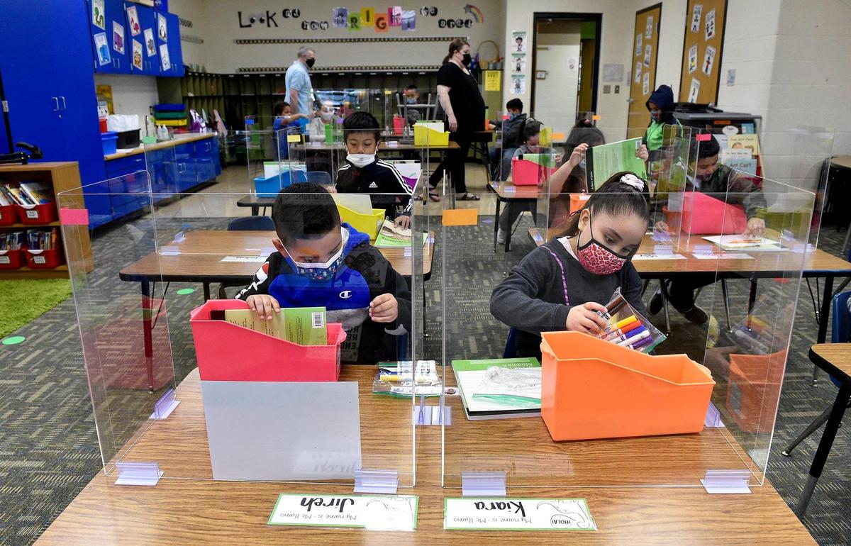 First-graders Jireh Hernandez and Kiara Zubia got to see their school supply bins for the first time at Douglass Elementary School on Wednesday.