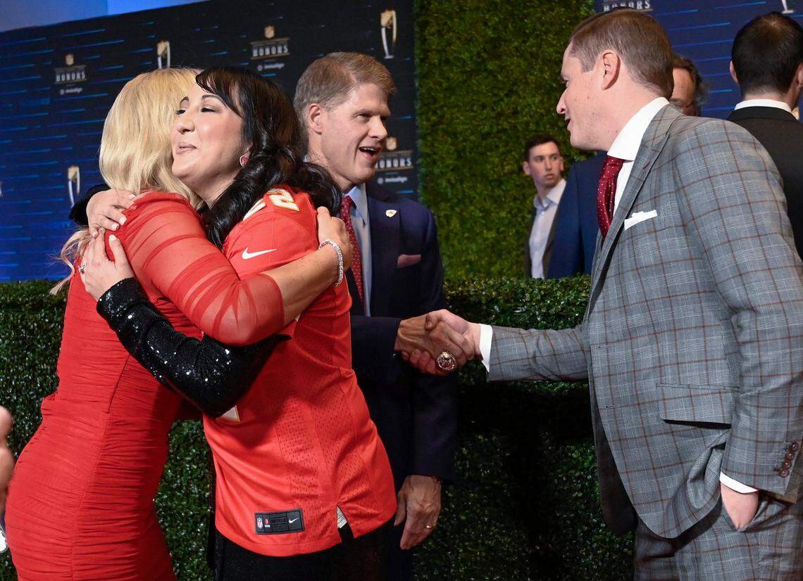 Tavia Hunt, from left, embraces Liberty’s Amy Patel, as Clark Hunt, Chiefs chairman and CEO, greets Patel’s husband, Joseph Rathermel before Thursday night’s NFL Honors show in Phoenix. Patel and Rathermel traveled to Arizona as the Chiefs’ nominee for the NFL’s 2022 Fan of the Year award.
