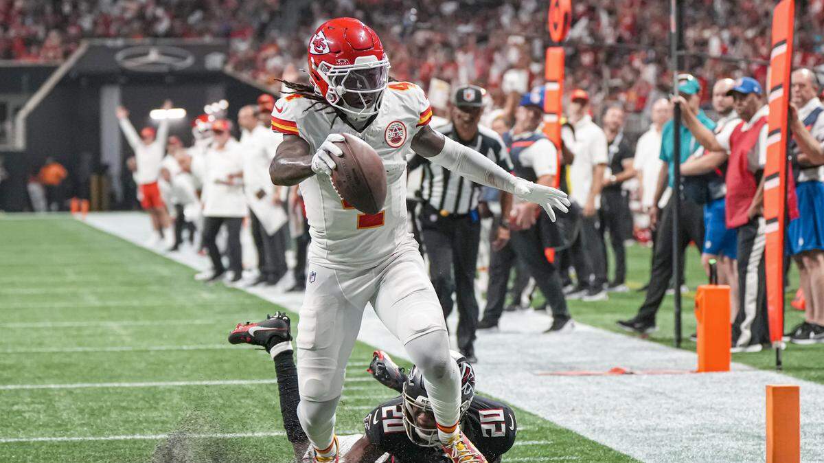 Kansas City Chiefs wide receiver Rashee Rice scores a touchdown past Atlanta Falcons cornerback Dee Alford during a Sunday night game at the Mercedes-Benz Stadium.