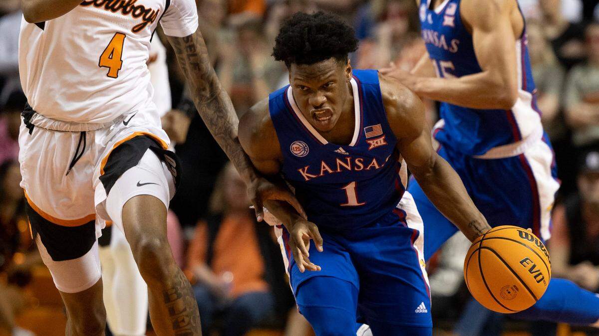 Kansas’ Joseph Yesufu drives past Oklahoma State’s Woody Newton in the second half of a Big 12 game in Stillwater, Okla., Tuesday, Feb. 14, 2023.