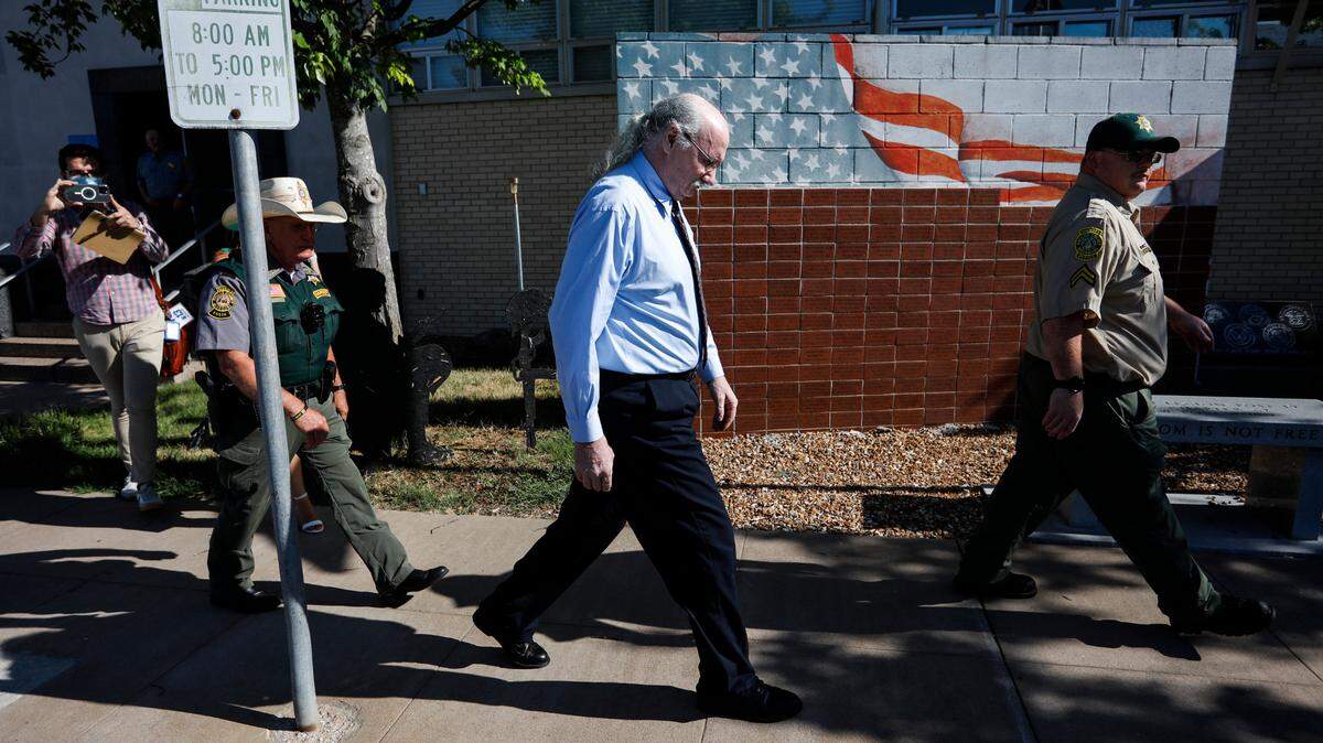 James Phelps (center) is escorted by two Dallas County Sheriff’s deputies as he leaves the Dallas County Courthouse after waiving his right to a preliminary hearing on charges he killed Cassidy Rainwater.