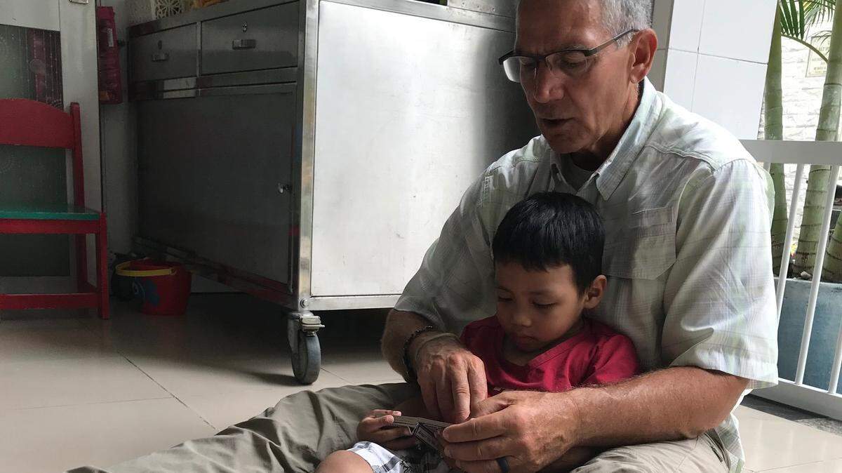 Former Mizzou athletic director Mike Alden spends time with a youngster at an orphanage during a recent trip to Vietnam.