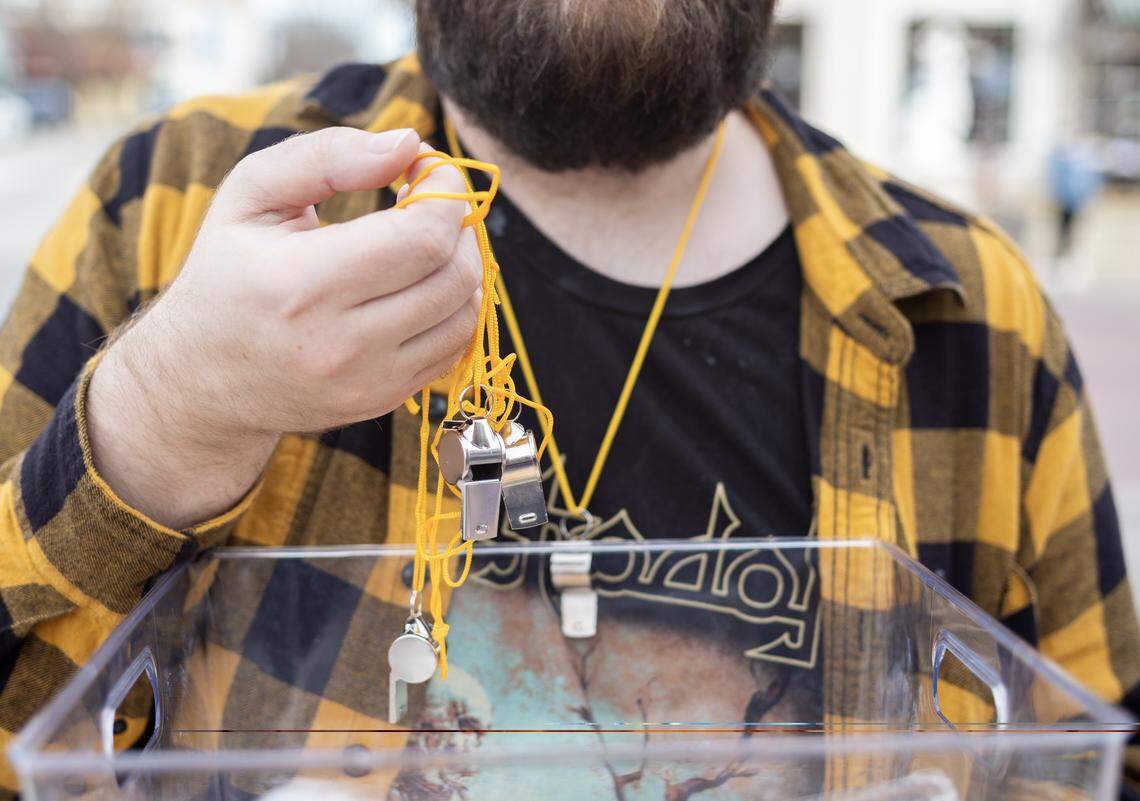Arthur Houchin handed out free whistles on Lawrence’s Massachusetts Street Wednesday after activists said there had been U.S. Immigration and Customs Enforcement activity in town.